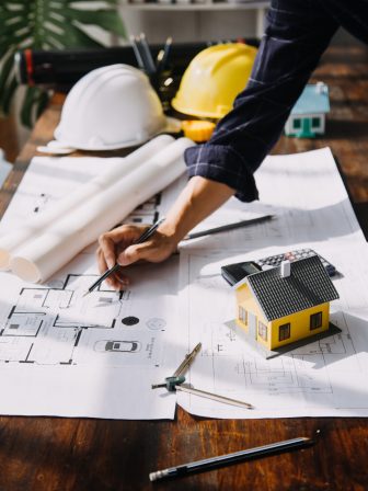 Construction and structure concept of Engineer or architect meeting for project working with partner and engineering tools on model building and blueprint in working site, contract for both companies.